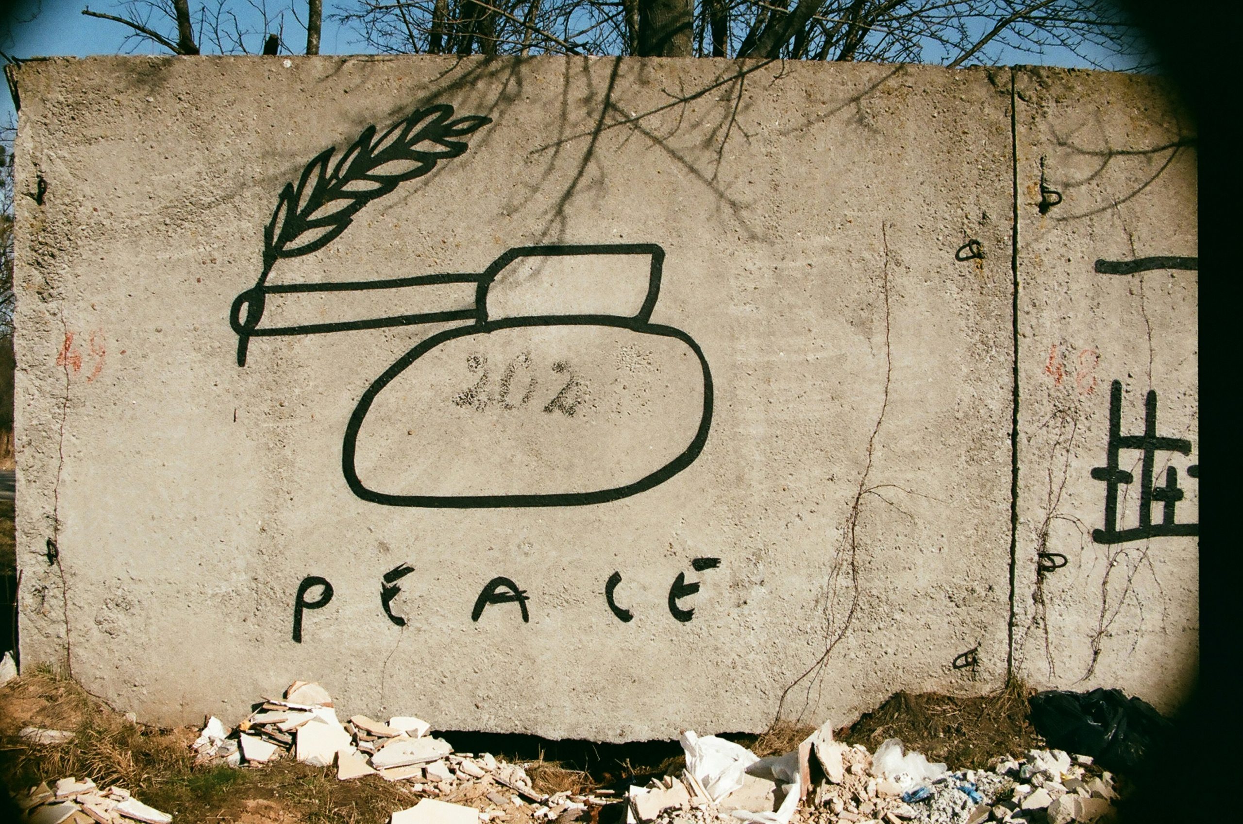 a cement sign with a picture of a vase and a wheat stalk on it.jpg